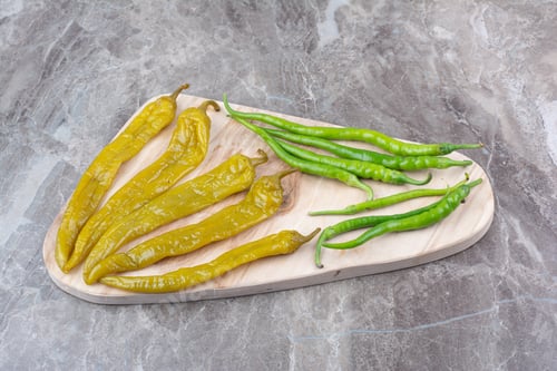 Preview: Fresh and fermented peppers on wooden board