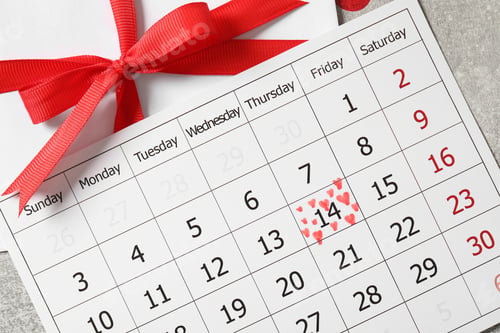 Preview: Calendar with marked Valentine's Day and gift on grey table, flat lay