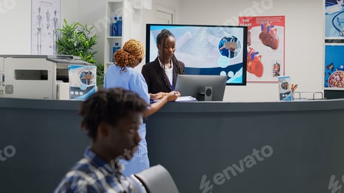 Preview: Team of clinical workers looking at form papers