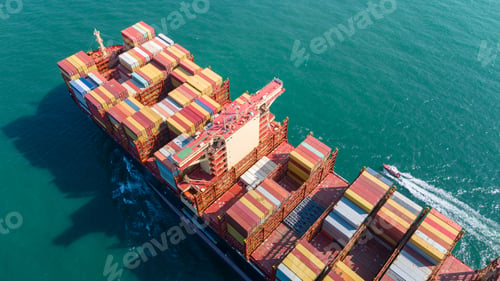 Preview: Aerial side view of cargo ship with contrail in the ocean sea ship carrying container an