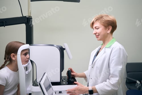 Preview: Doctor ophthalmologist examines the eyes of girl on modern equipment