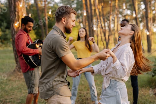 Preview: A beautiful couple dancing on the background of friends having fun