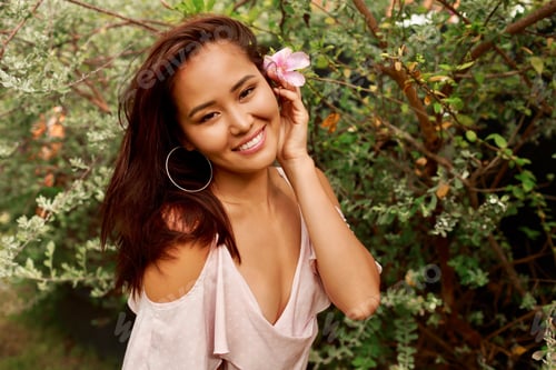 Preview: Beauty portrait of Asian girl with beautiful exotic face posing in garden.