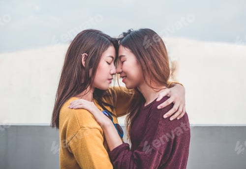 Preview: Asia lesbian LGBT Couple hug and nose kiss on rooftop
