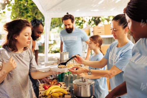 Preview: Individuals volunteering at a food bank