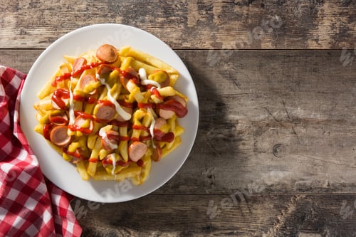 Preview: Typical Latin America Salchipapa. Sausages with fries, ketchup,
