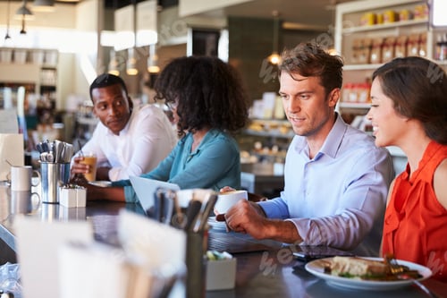 Preview: Group Enjoying Business Lunch At Delicatessen Counter