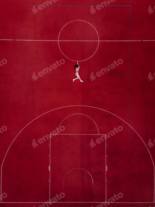 Preview: Abstract aerial shot of woman in swimwear hanging holding a circle on basketball field. SWAG concept