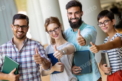 Preview: Happy group of success students studying and working together in a college library