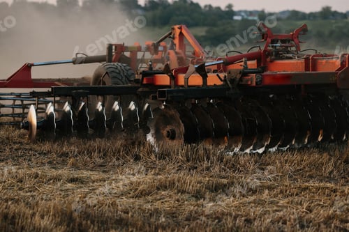 Preview: A tractor with a large disc harrow for tillage. Farmer work concept.