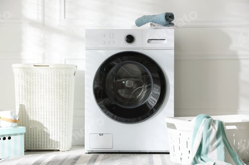 Preview: Washing machine, laundry baskets and towels in room. Interior design