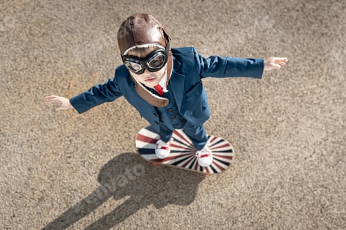 Preview: Happy child playing with toy wings outdoor