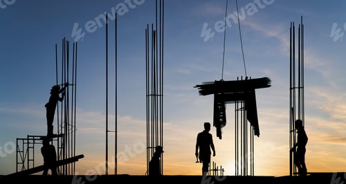 Preview: Silhouette workers on high building site with sunset sky background