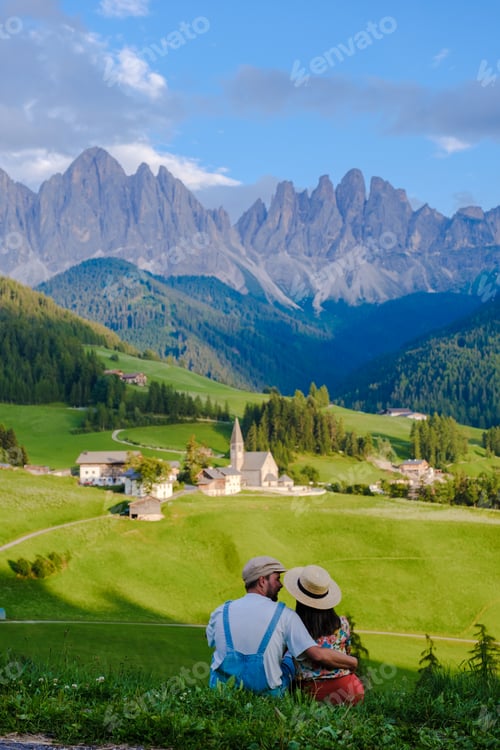 Preview: Couple viewing the landscape of Santa Maddalena Village in Dolomites Italy