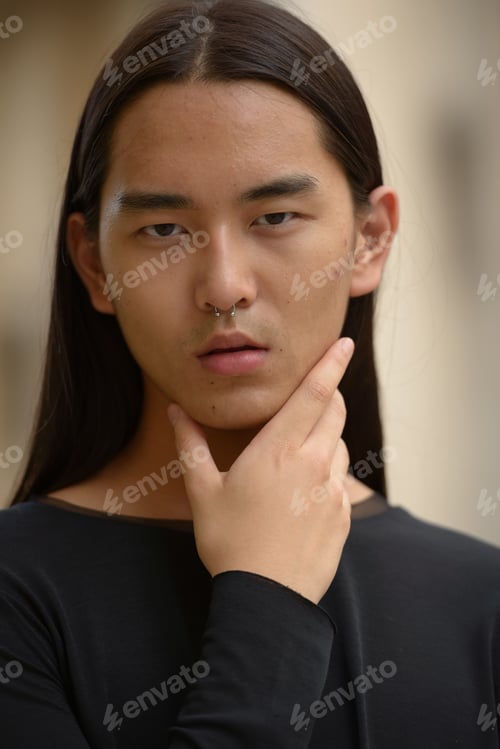 Preview: Portrait of young Asian man with long hair
