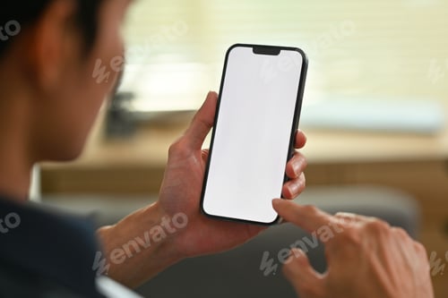 Preview: Close up view of man holding and typing text message on mobile phone.