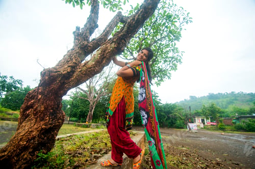Preview: Young girl near tree trunk and she enjoying fresh air outdoors