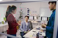 Preview: Diverse business team collaborating on glass board in modern office, strategizing for new project wi