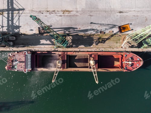 Preview: cargo ship loading in port at sunset