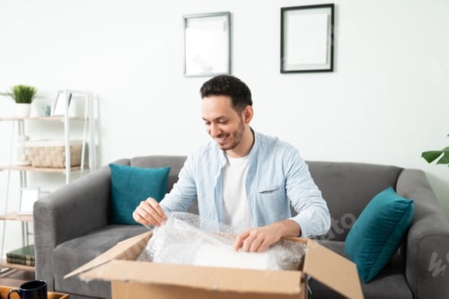 Preview: Hispanic man unpacking a delivery box