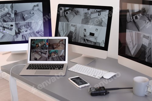 Preview: Modern computers with video broadcasting from security cameras at guard's workplace indoors