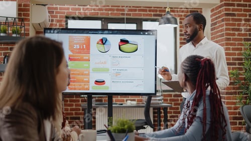 Preview: Company worker pointing at presentation on monitor