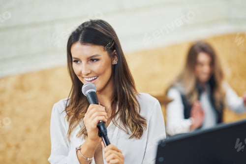 Preview: Caucasian woman singing into microphone in studio