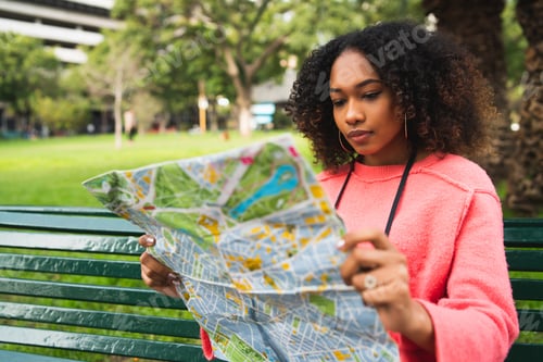 Preview: Afro-american woman looking at a map.