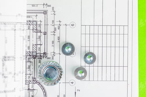 Preview: Nuts and bolts close-up over house plan