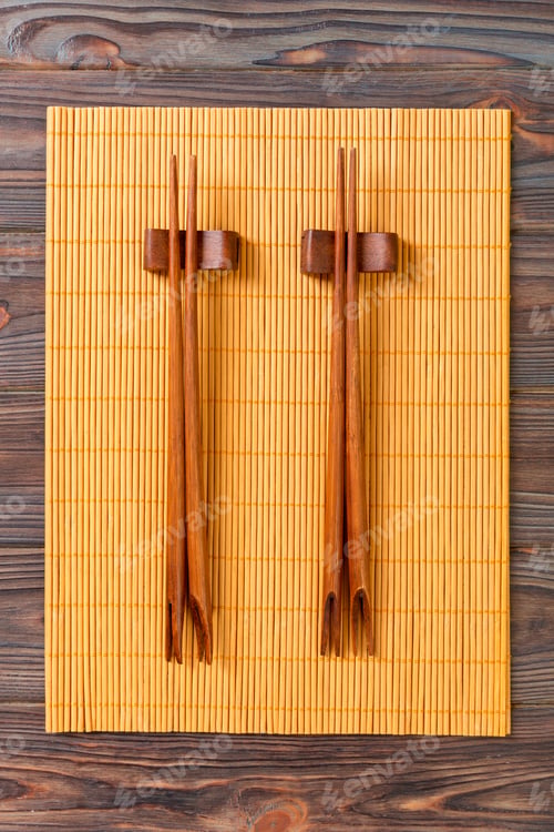 Preview: two sets of sushi chopsticks on wooden bamboo background, top view