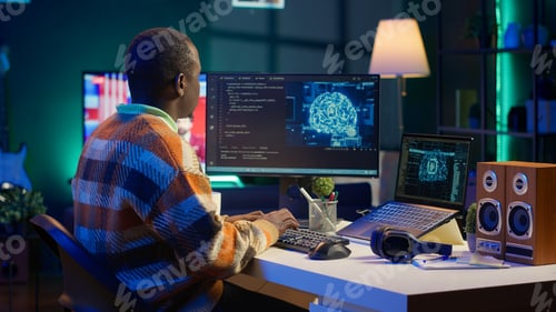 Preview: Professional male developer manages neural network at desk