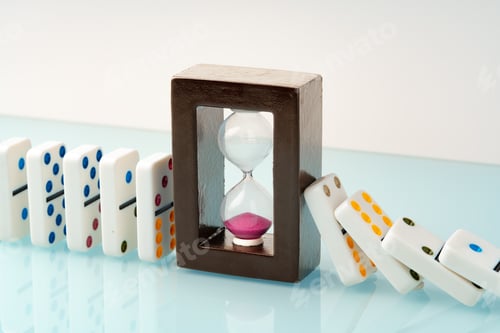 Preview: Hourglass and domino tiles on blue background. Time limit concept