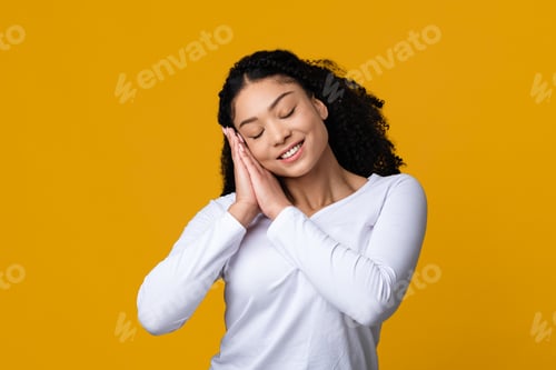 Preview: Sweet Dreams. Beautiful calm african american lady with serene face pretending sleeping