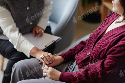 Preview: Woman Reassuring Young Adult Caucasian Woman during Session