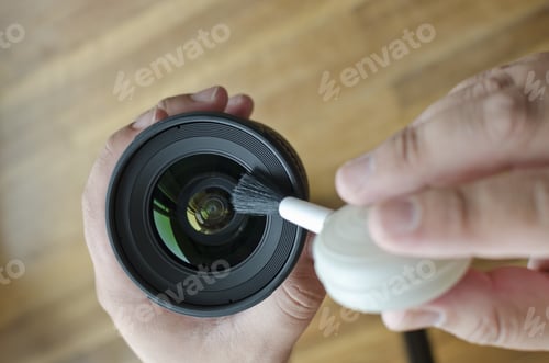 Preview: Top view of hands cleaning the lens