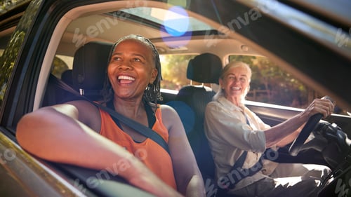 Preview: Two Senior Female Friends Enjoying Day Trip Out Driving In Car Together
