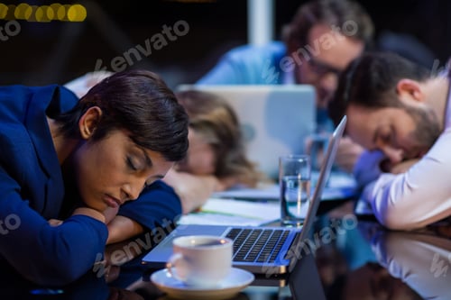 Preview: Tired Businesspeople Sleeping In Office At Night