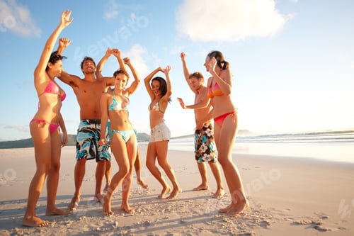 Preview: Cheerful teenagers dancing on the beach. Portrait of happy teenagers dancing on the beach.