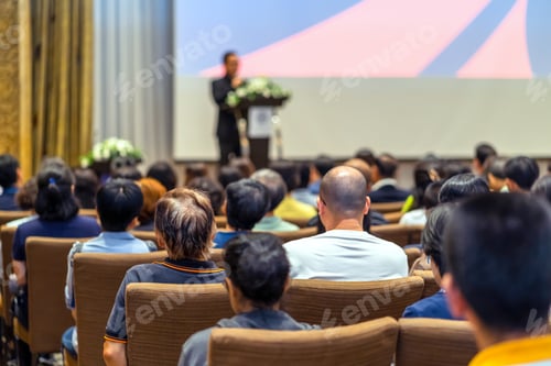 Preview: Back side of audience listening the Speaker with podium on the stage in the conference hall