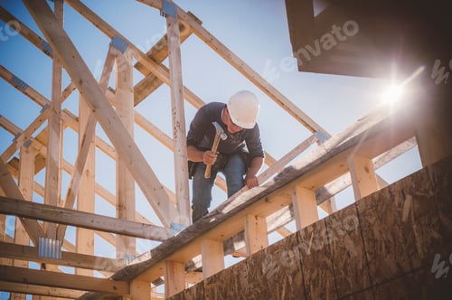 Preview: Builder working on rooftop frame of building