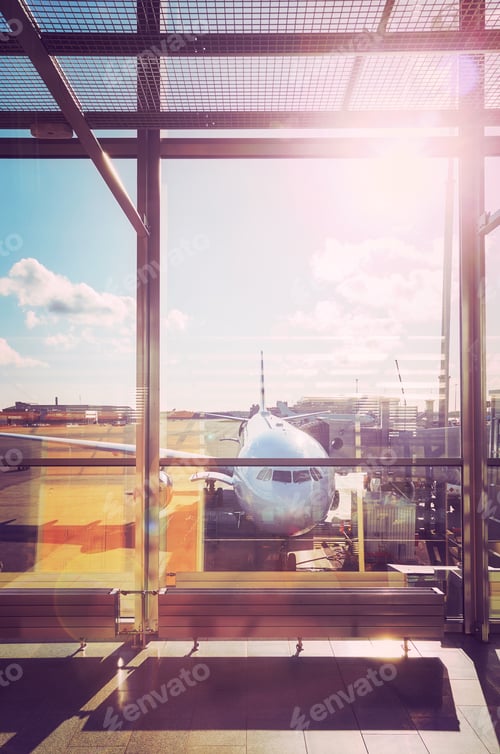 Preview: Departure hall at an airport at sunset.