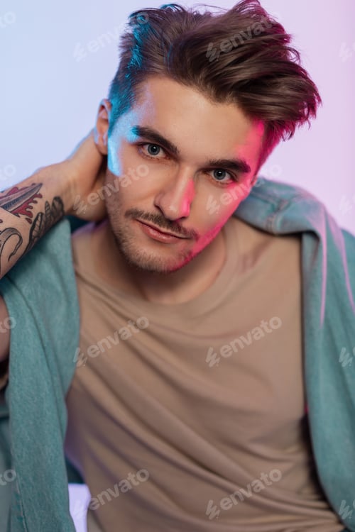 Preview: Handsome fashion model man in fashionable clothes in studio. Male portrait