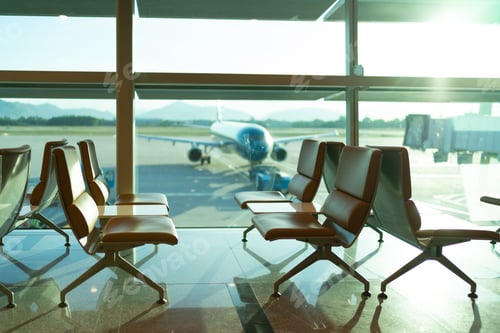 Preview: Airport departure lounge seating with aircraft preparing for flight in the background