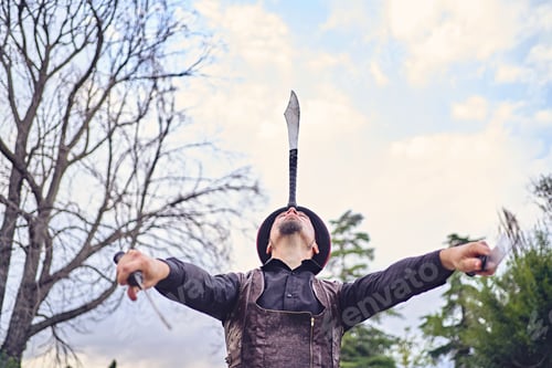 Preview: Man juggling knives in park