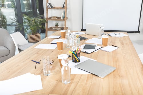 Preview: empty business workplace with disposable cups, digital devices and papers in office