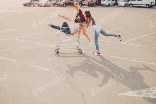 Preview: Hipster friends having fun with shopping cart
