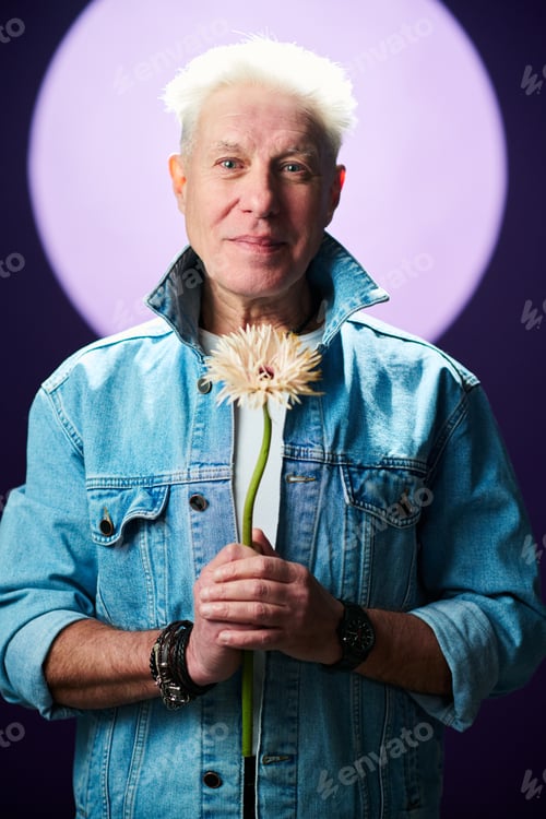 Preview: Romantic senior man with flower standing against full moon at night