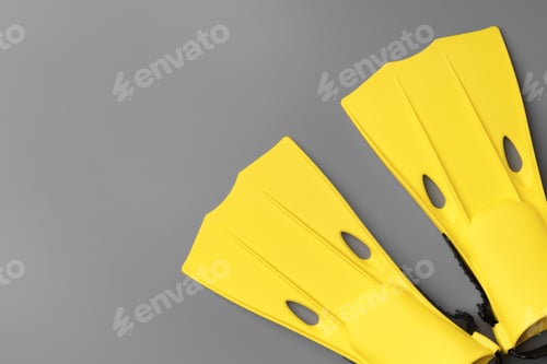 Preview: Yellow diving flippers on gray background top view