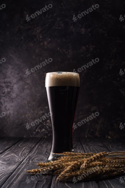 Preview: Glass of Beer With Foam Near Wheat Spikes on Wooden Table