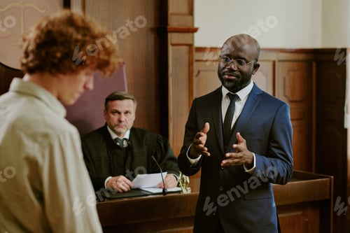 Preview: Black Middle Aged Man Explaining Case to Caucasian Teenager in Courtroom